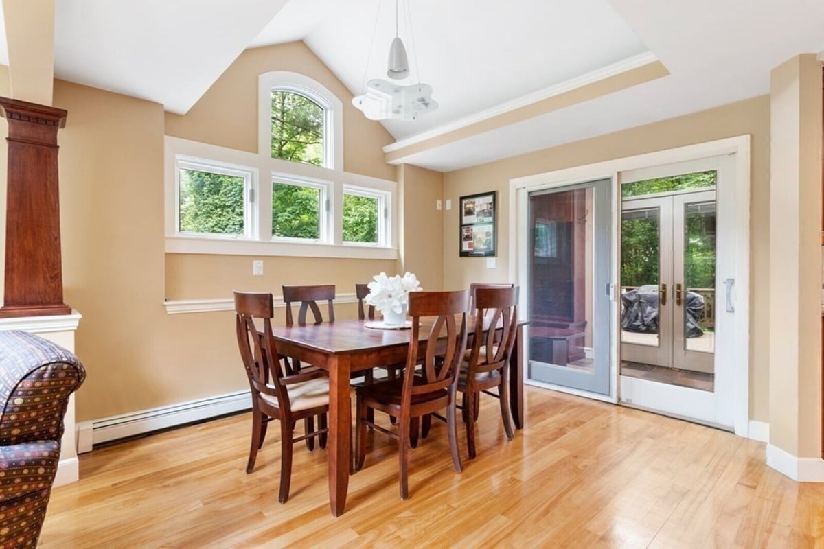 Acton home remodel dining room showcasing wooden table and detailed chairs by Thomas Buckborough & Associates
