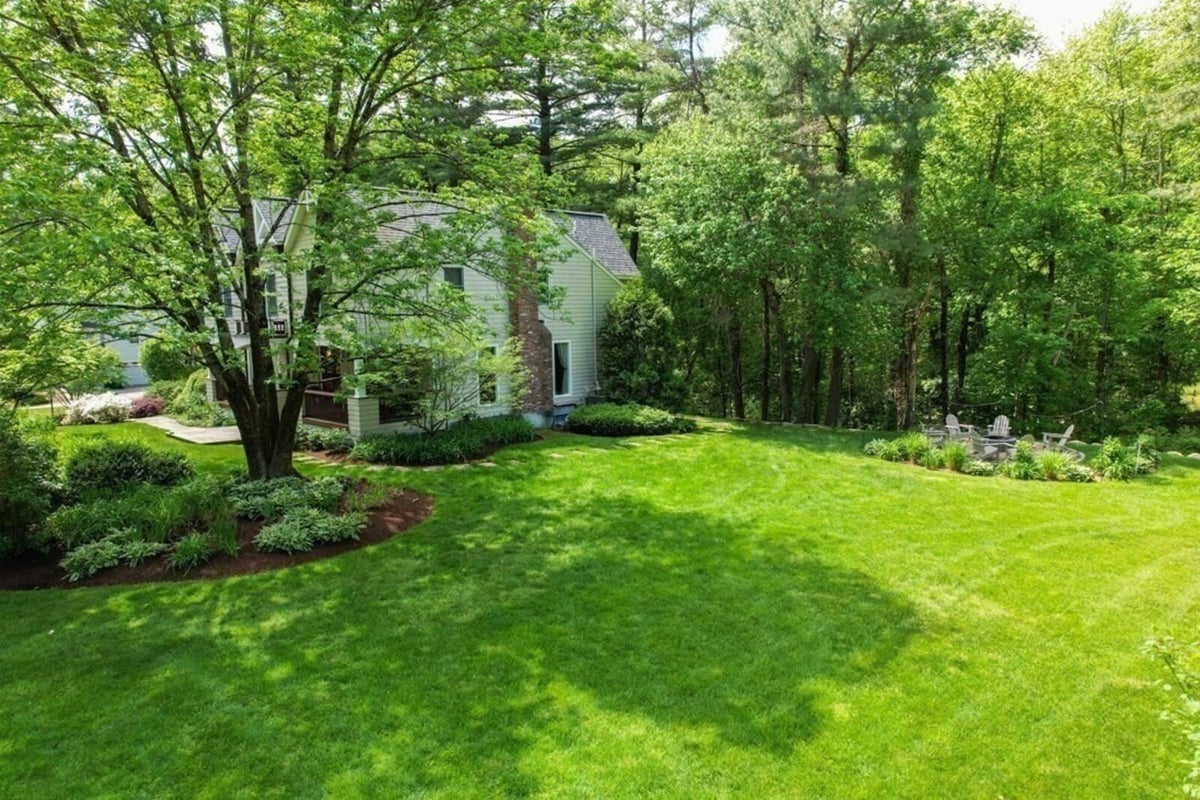 Beautifully landscaped home exterior in Acton MA from recent renovation by Thomas Buckborough & Associates