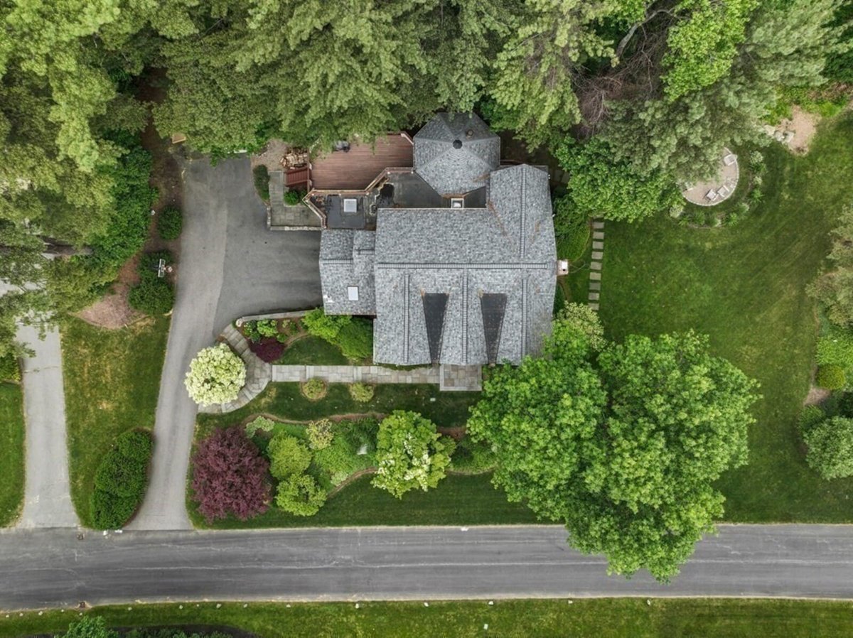Exterior aerial view of remodeled Acton MA home surrounded by lush landscaping by Thomas Buckborough & Associates