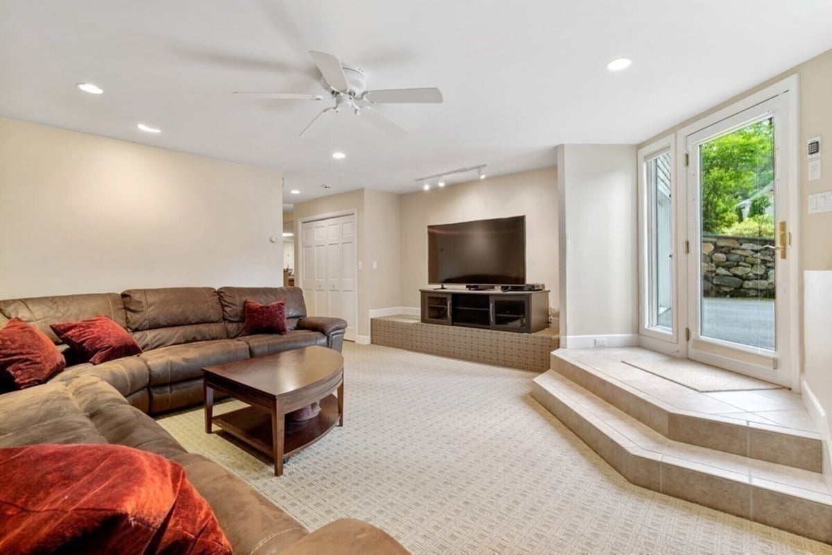 Finished lower-level living room with natural light in Acton MA, renovated by Thomas Buckborough & Associates
