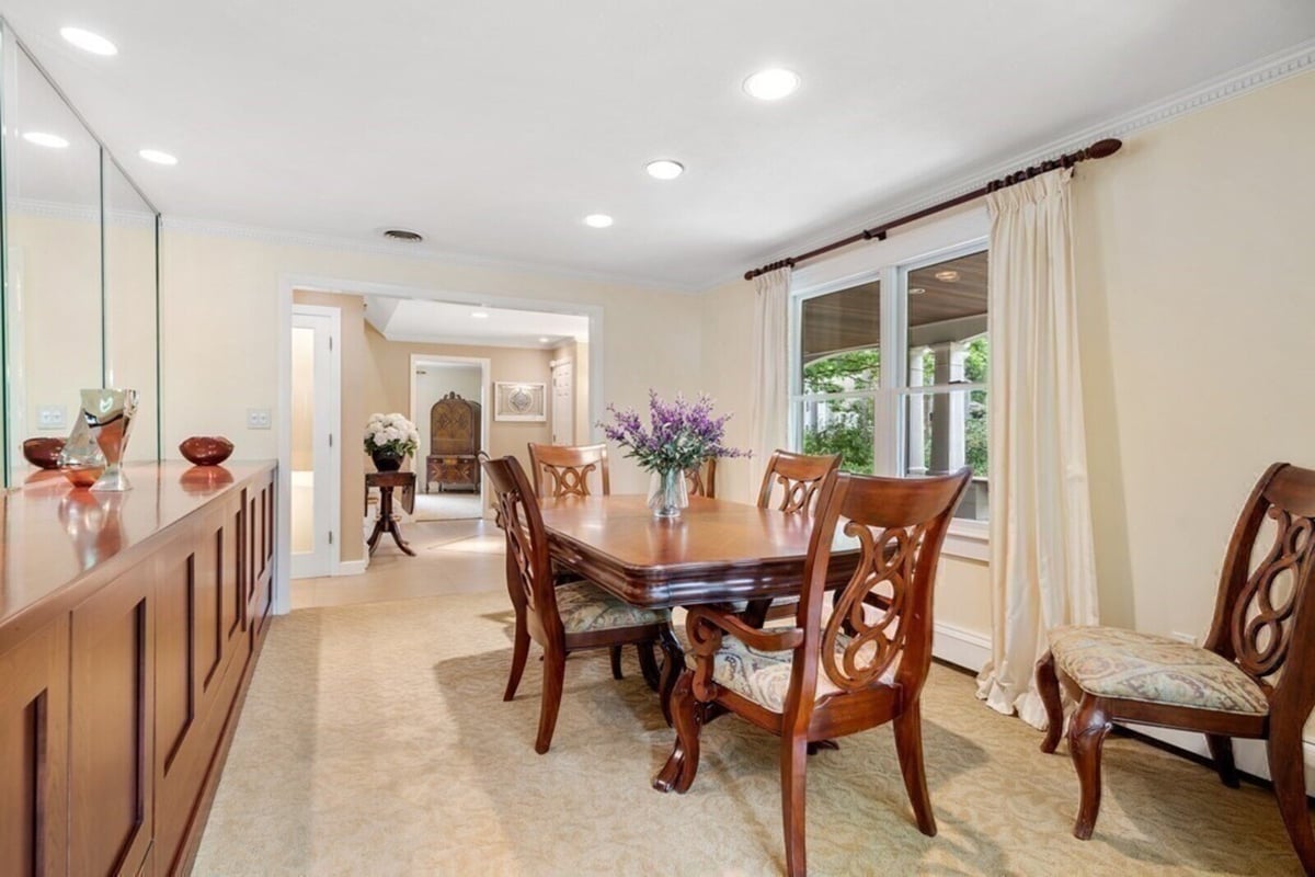 Formal dining room in an Acton, MA remodeled home by Thomas Buckborough & Associates, featuring elegant wood furniture