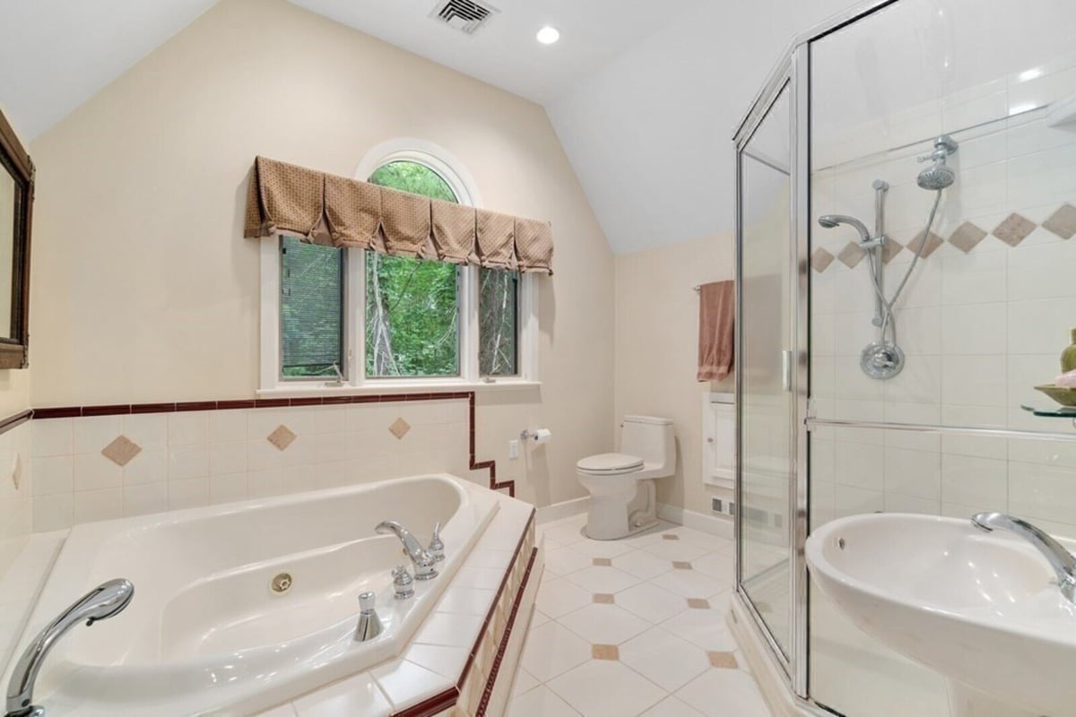 Luxurious bathroom remodel with soaking tub and glass shower by Thomas Buckborough & Associates in Acton MA