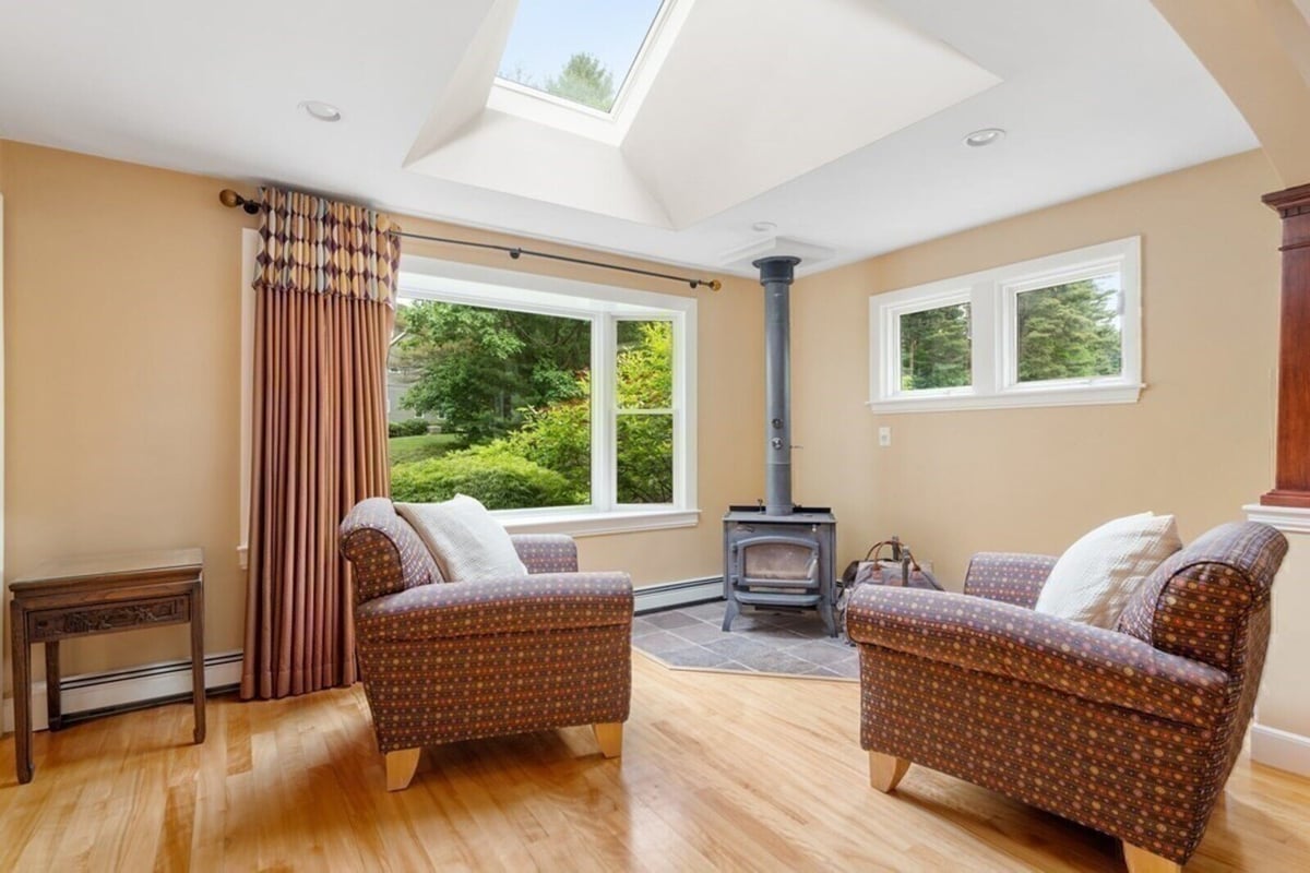 Relaxing sitting area remodel with abundant natural lighting in Acton, MA by Thomas Buckborough & Associates