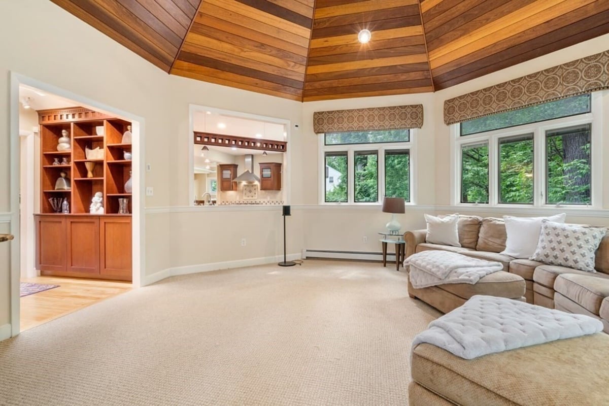 Spacious seating area with beige sectional sofa in remodeled Acton home by Thomas Buckborough & Associates