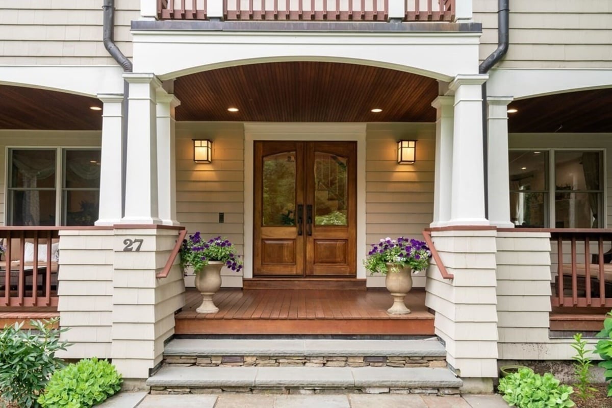 Welcoming entryway of a remodeled home in Acton, MA by Thomas Buckborough & Associates featuring double wooden doors