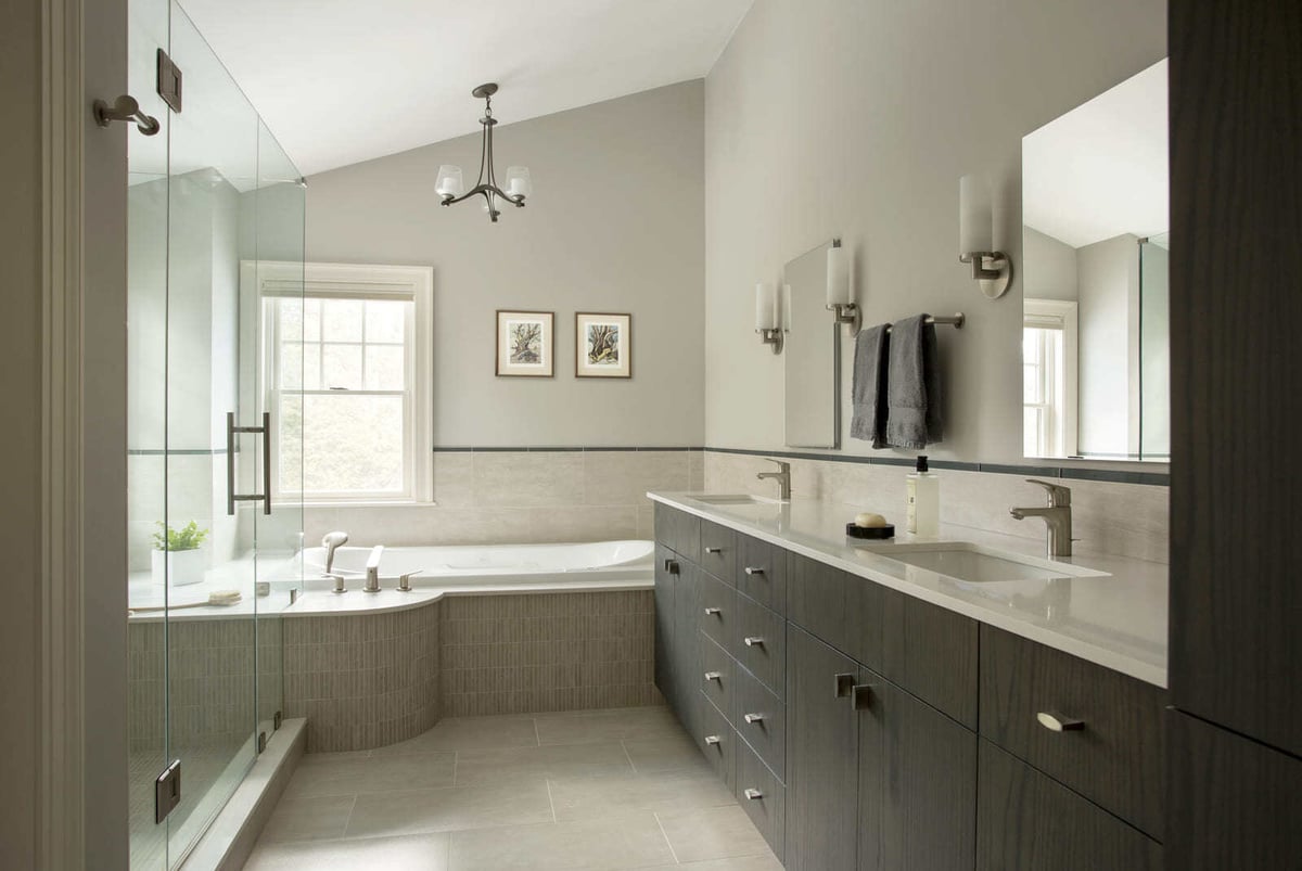 Elegant bathroom renovation with dark wood cabinetry, sleek fixtures, and a neutral color palette by Thomas Buckborough & Associates, Acton, MA